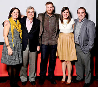 The Family Caldwell—Julie, Stokely, Lauren and Gray—takes a photo break with Dale Earnhardt Jr. (center) at one of the driver’s Foundation events.