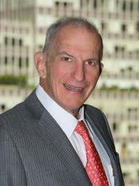 A portrait photo of Stephen Susman wearing a suit and tie.